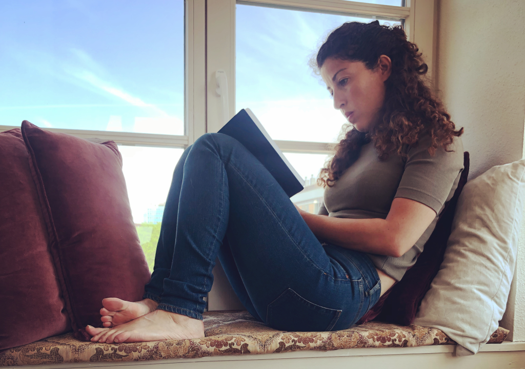 Hadar Yonna, founder of Mind Your Dreams, writing a dream journal